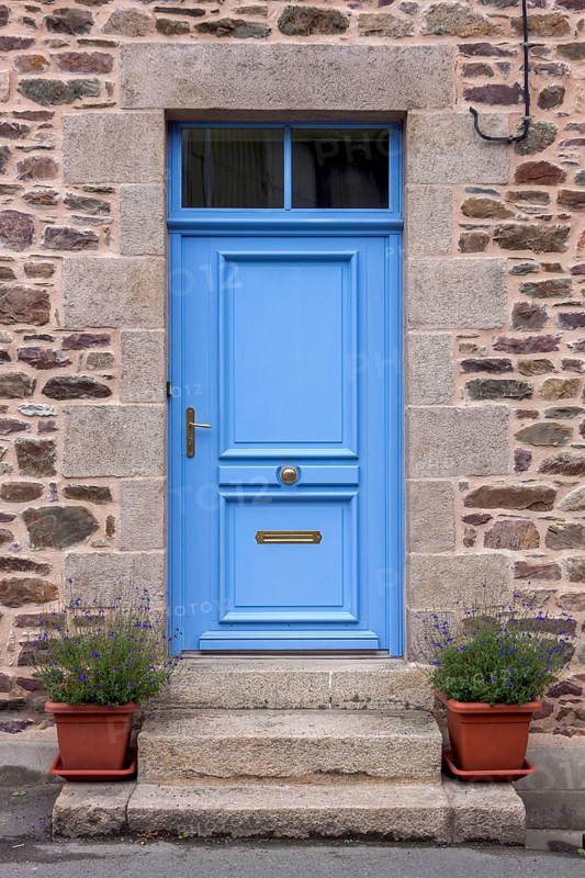 House facade with blue entrance door and two flower pots on steps, Pontrieux, Departement Cotes dArmor, Brittany, France, Europe