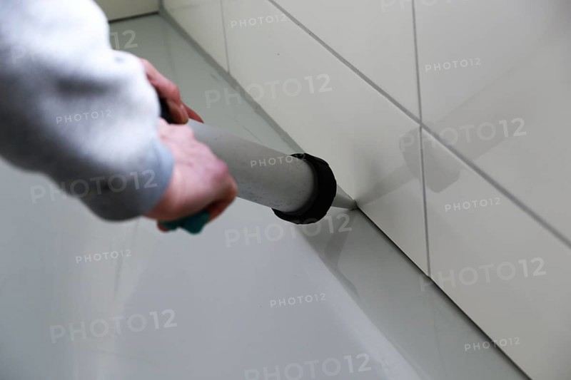 Grouting work. Tiler grouting in a new bathroom