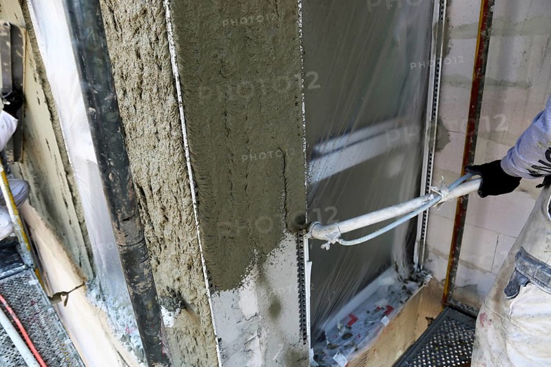 Plasterer plastering an exterior wall