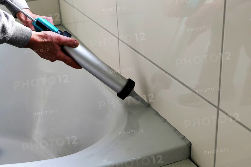 Grouting work. Tiler grouting in a new bathroom