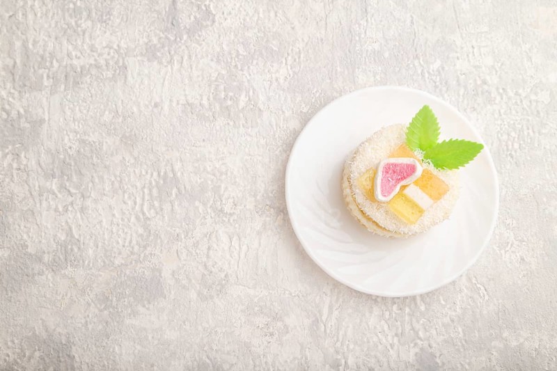 Decorated cake with milk and coconut cream on a gray concrete background. top view, flat lay, copy space
