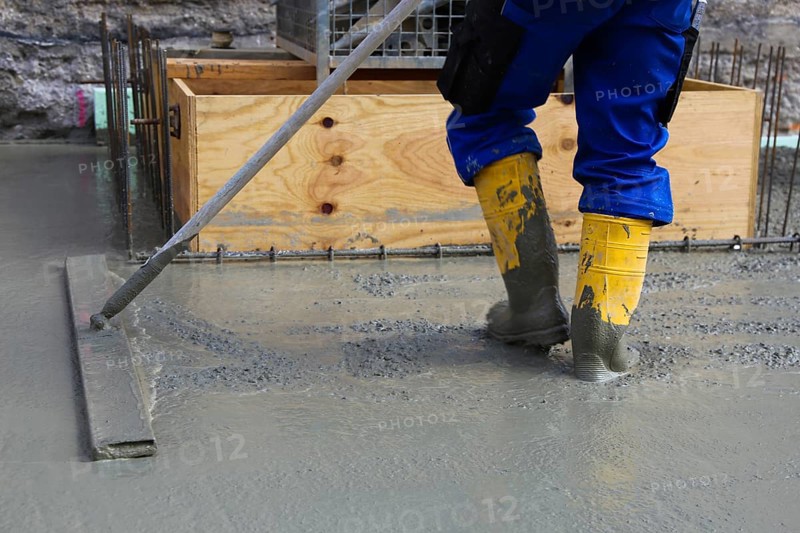 Concreting a floor slab with ready-mixed concrete on the construction site of a residential building