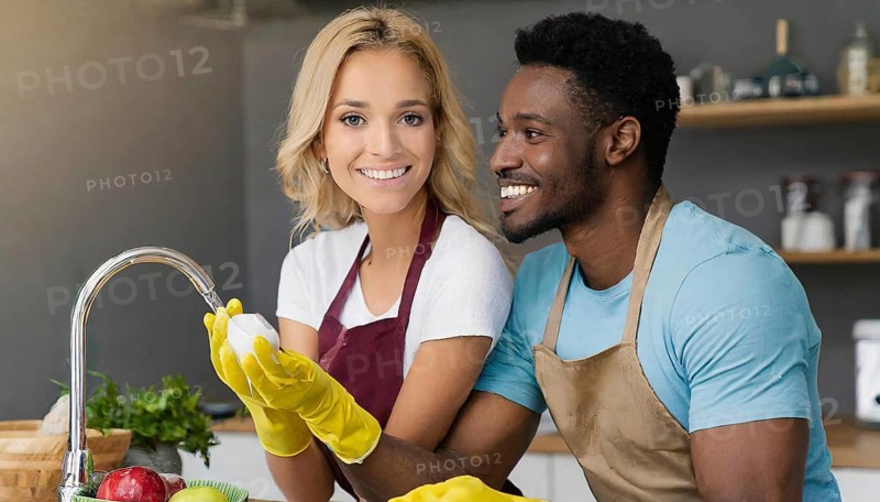 AI generated, woman, woman, man, men, 30, 35, blonde, blond, blonde, kitchen, sink, kitchen table, dishes, washing up, washing up, plates, cups, glasses, dishcloth, gloves, cleaning, water, polishing cloth, polishing, clean, cleanliness, housewife, mother, family, two people, an African