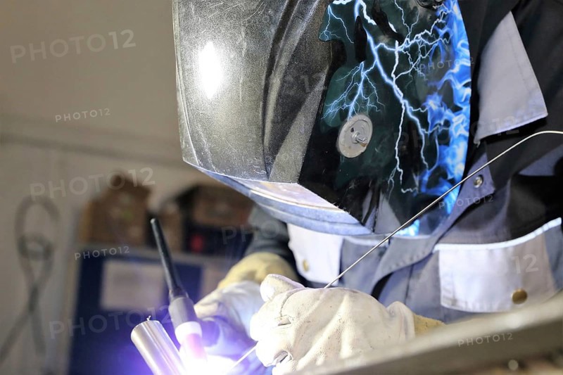 Metalworker during welding work in his workshop