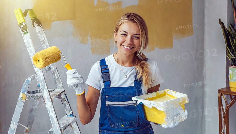 AI generated, woman, woman, a young woman paints a wall with new paint, yellow, yellow, yellowing, renovation of old flat, paint roller, ladder, paint, 20, 25, years, a, a person, daughter, student, pastime, family, girl, smiling, smiling, fun at work, laughing, laughing, laughing, dungarees, jeans