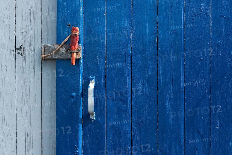 Blue sliding door with handle and red wooden splint to close the wooden wall of a fisherman's hut, Hvide Sande, Midtjylland region, Denmark, Europe