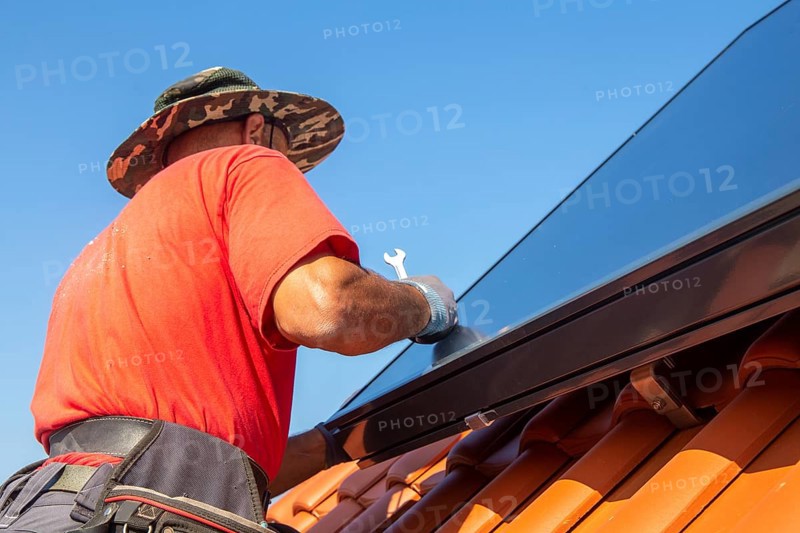 Installation of solar collectors for solar thermal energy. The company Hanschke Solarmontagen installs solar panels on a newly built apartment block in Mutterstadt (Palatinate)