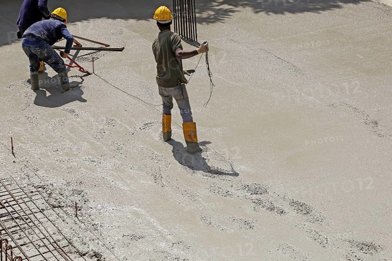 Concreting a floor slab with ready-mixed concrete on the construction site of a residential building