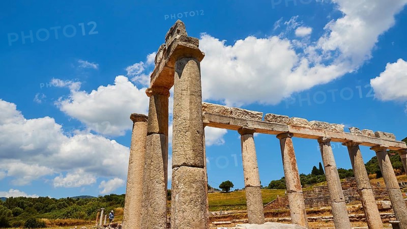 Ancient portico under a blue sky with white clouds, Archaeological site, Ancient Messene, capital of Messinia, Messini, Peloponnese, Greece, Europe