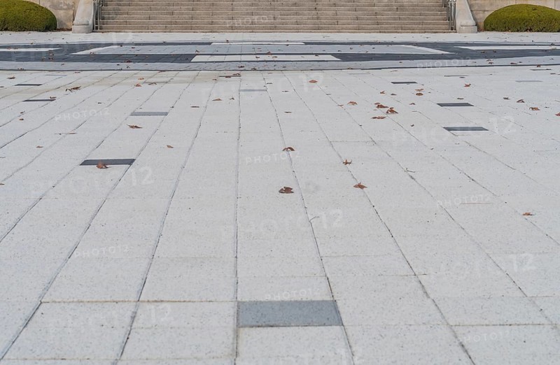 Closeup of concrete tile plaza with staircase in background in South Korea