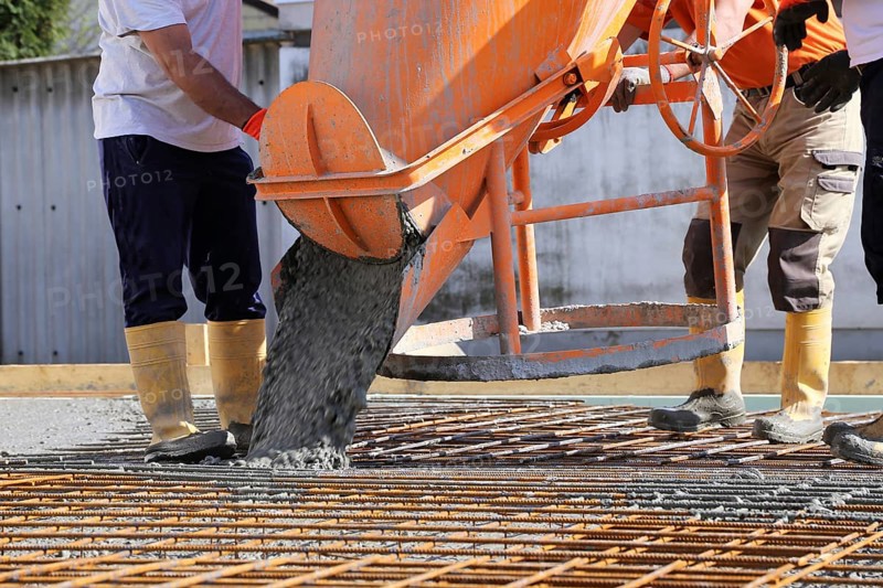 Concreting a floor slab with ready-mixed concrete on the construction site of a residential building