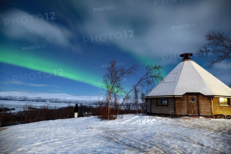 Northern Lights (aurora boreailis) over a small wooden hut in Swedish Lapland, Abisko, Kiruna, Sweden, Europe