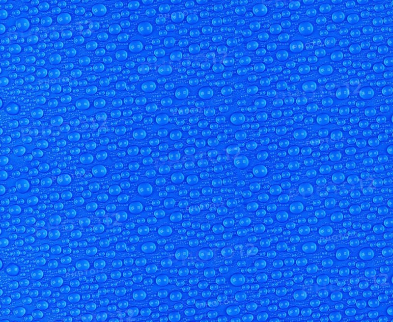 Many small water drops on a blue surface