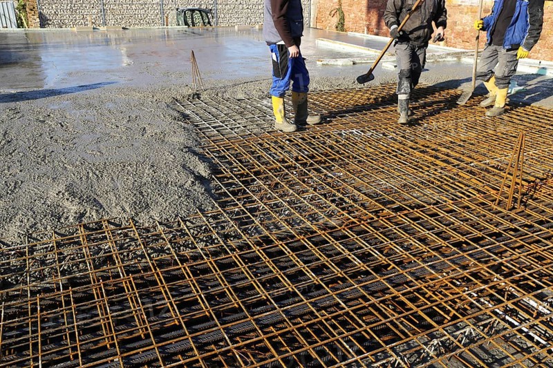 Concreting a floor slab with ready-mixed concrete on the construction site of a residential building