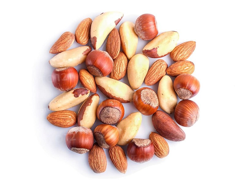 Piles of various nuts isolated on white background. hazelnut, brazil nut, almond, pumpkin seeds, cashew. top view