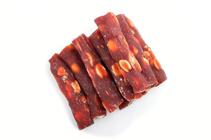 Brown traditional turkish delight (rahat lokum) with peanuts isolated on white background. top view, flat lay, close up