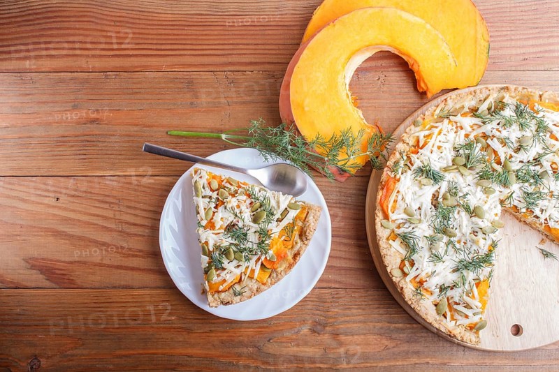 Sweet pumpkin pie with cheese and dill on brown wooden background. top view. copy space