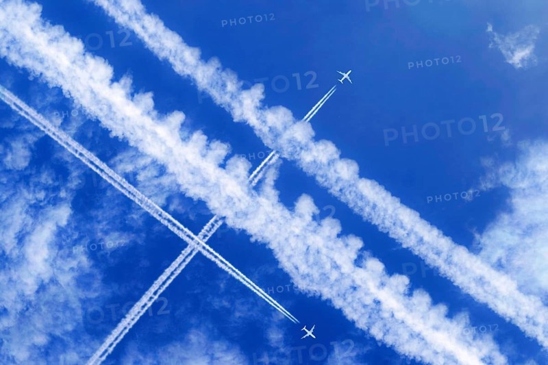 Vapor trails and passenger jets high in the sky