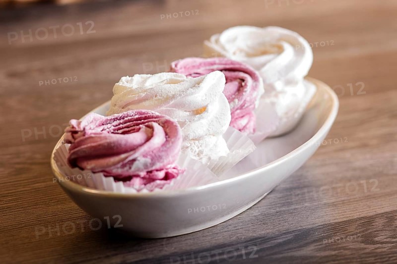 Pink and white homemade marshmallows (zephyr) on a gray wooden background
