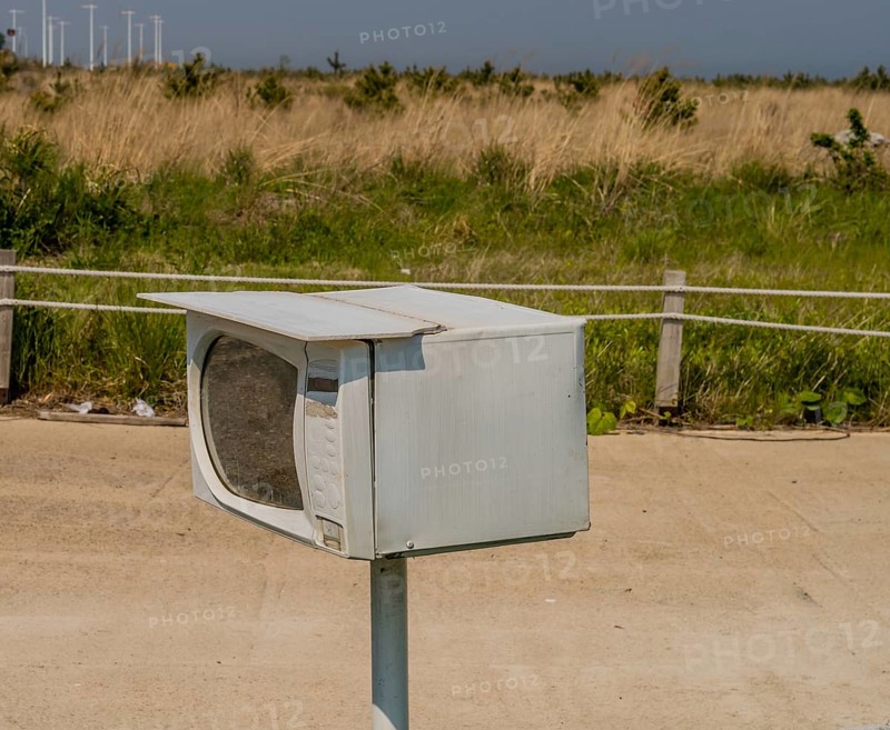 Small microwave oven on metal pole used as mailbox in South Korea