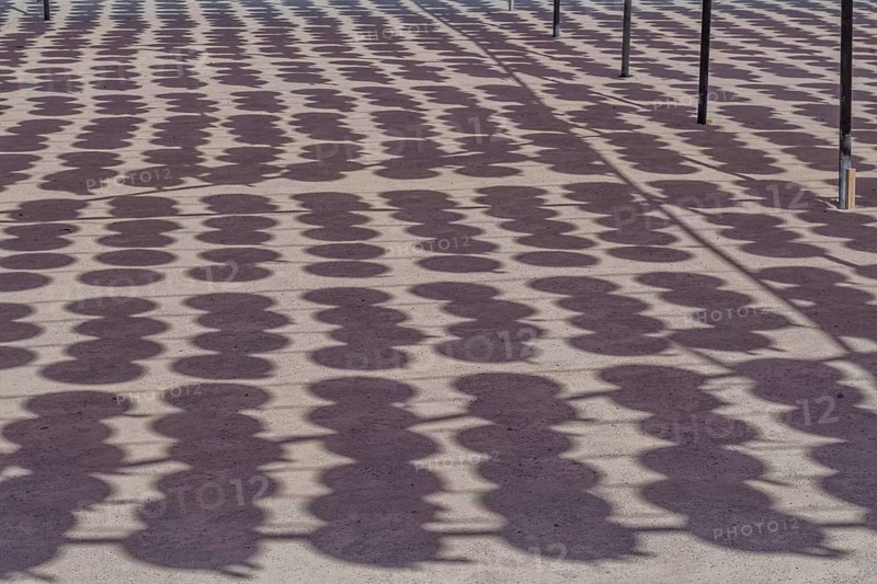 Shadows of oriental paper lanterns hanging from wires at Buddhist temple in South Korea