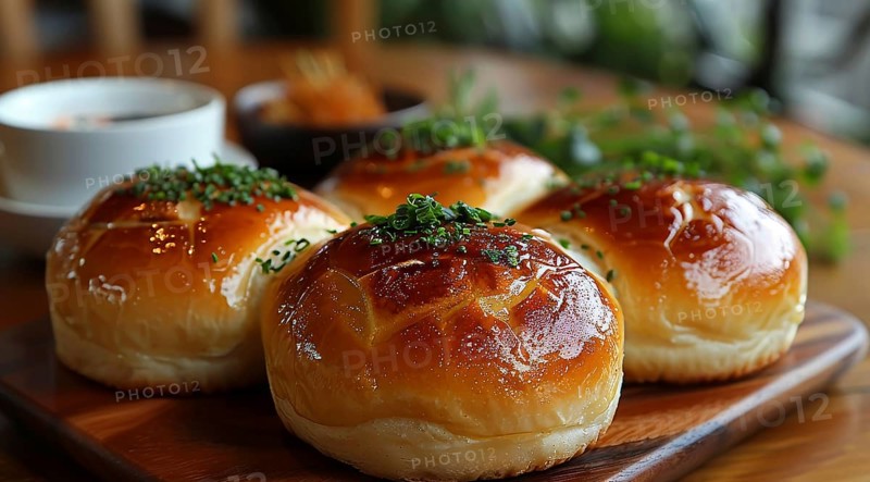 Glossy Japanese bread rolls topped with sesame seeds and parsley on a wooden serving board, ai generated, AI generated