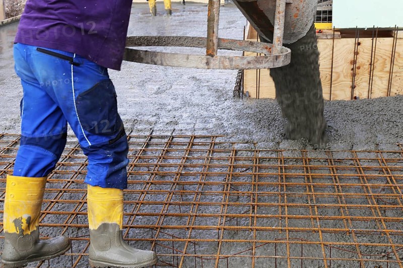 Concreting a floor slab with ready-mixed concrete on the construction site of a residential building