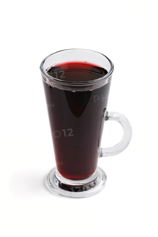 Glass of red grape juice isolated on white background. Morninig, spring, healthy drink concept. Side view, close up