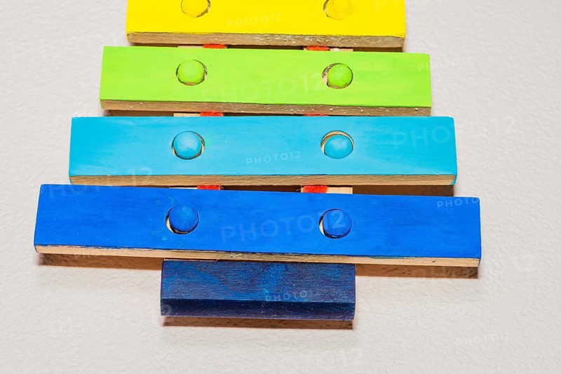 Closeup of small wooden toy xylophone hand painted in bright primary colors