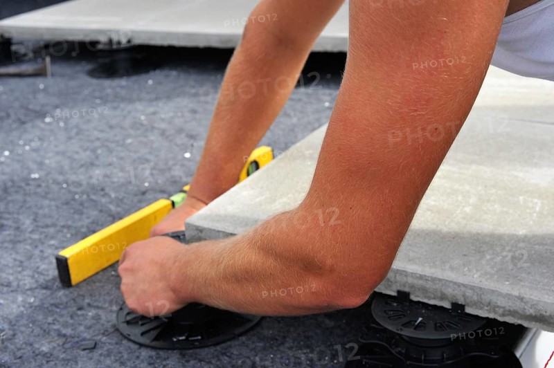 Worker lays paving stones