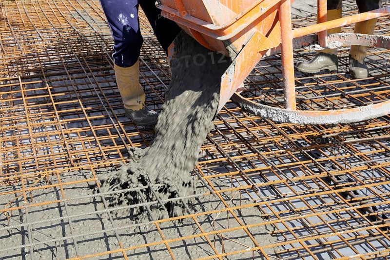 Concreting a floor slab with ready-mixed concrete on the construction site of a residential building