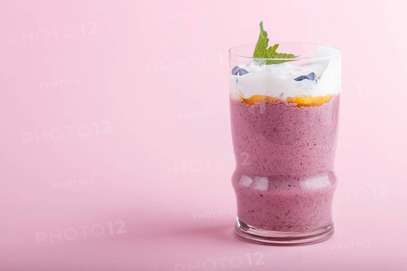 Smoothie with honeysuckle, linen and chia in a glass on pink pastel background. side view, close up, copy space