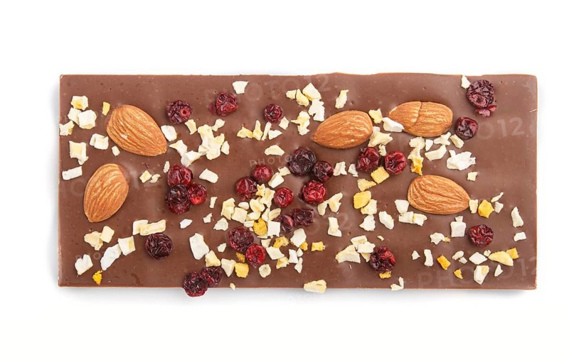 Milk chocolate bar with almonds and dried fruits isolated on white background. top view, flat lay