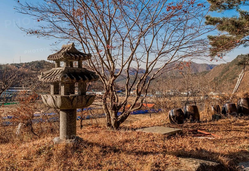Korean concrete spirit house in shape of three story pagoda in rural countryside in South Korea