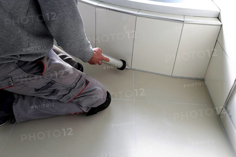 Grouting work. Tiler grouting in a new bathroom