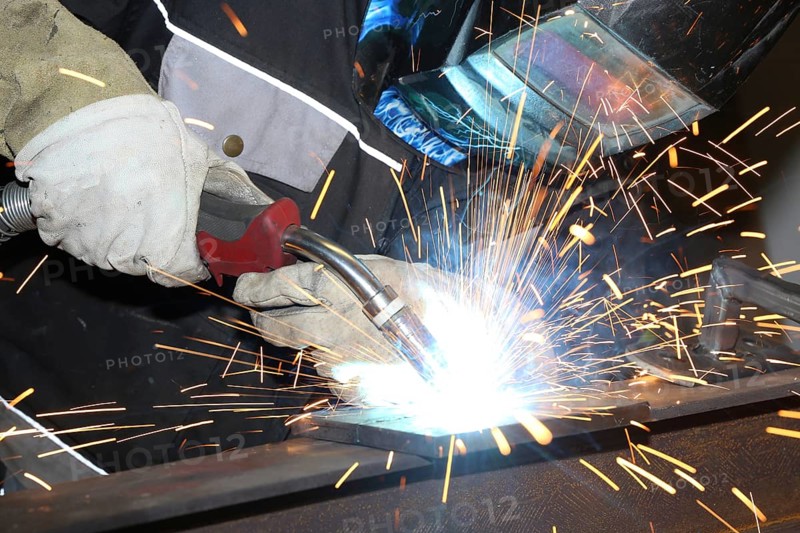 Metalworker during welding work in his workshop