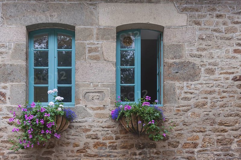 Two windows in a typical granite house, floral decoration, Dinan old town, Brittany, France, Europe