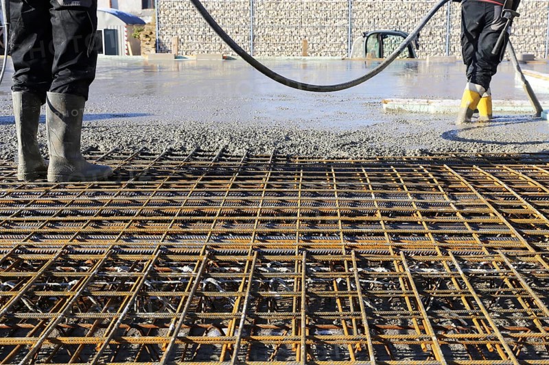 Concreting a floor slab with ready-mixed concrete on the construction site of a residential building
