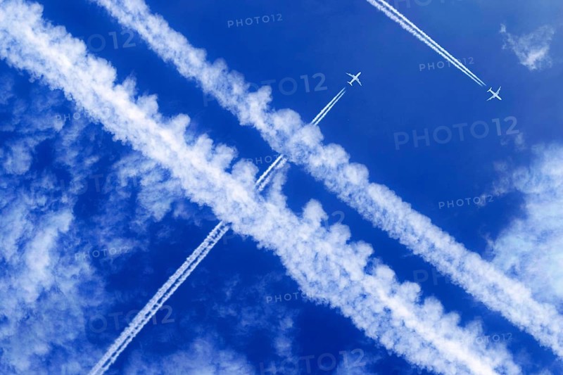 Vapor trails and passenger jets high in the sky