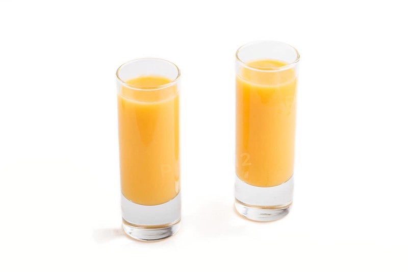 Sweet egg liqueur in glass isolated on white background. Side view, close up