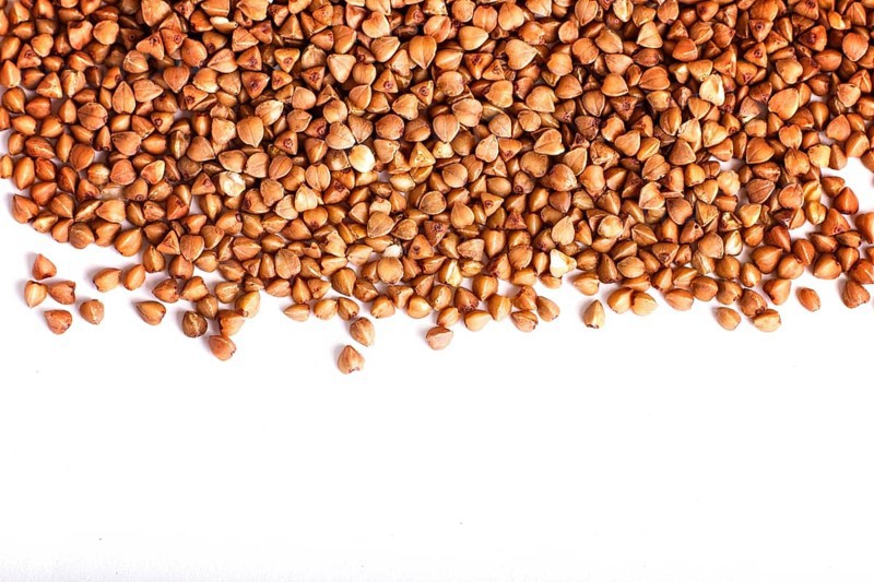 Texture of buckwheat isolated on white background. Top view