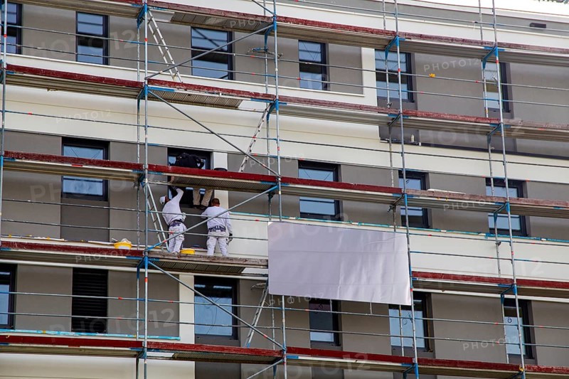 Painter painting the facade of a new apartment building