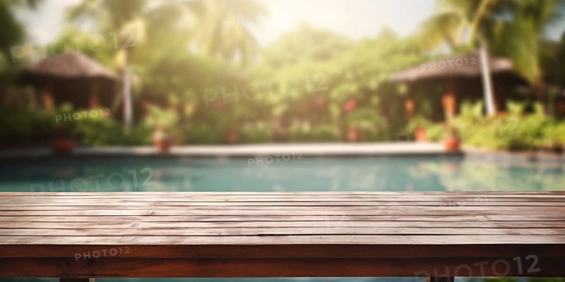Wooden table with troical garden and swimming pool in blurry background. KI generiert, generiert AI generated