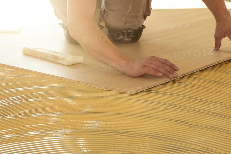 Craftsmen laying herringbone parquet professionally