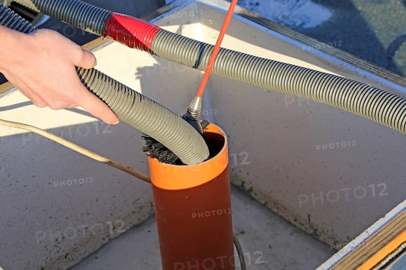 Workers from Abfluss AS clean the exhaust air ducts in an apartment block in Mannheim