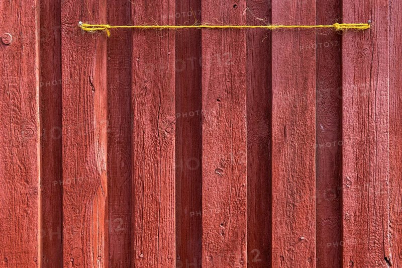 Red wooden wall of a fisherman's hut with yellow string, Hvide Sande, Midtjylland region, Denmark, Europe