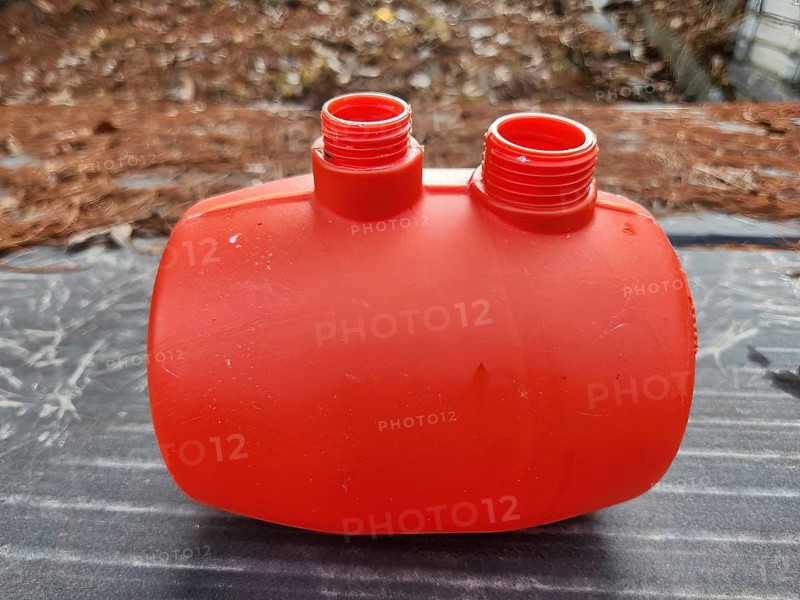 Orange plastic water tank for toy water gun with blurred background in South Korea