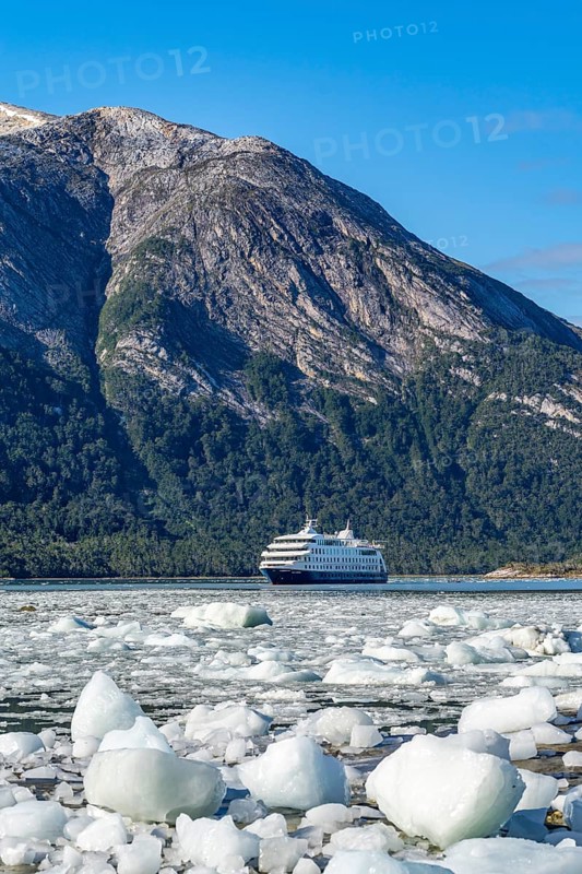 Cruise ship Stella Australis anchored between ice floes in Pia Bay in front of the Pia Glacier, Alberto de Agostini National Park, Avenue of the Glaciers, Chilean Arctic, Patagonia, Chile, South America