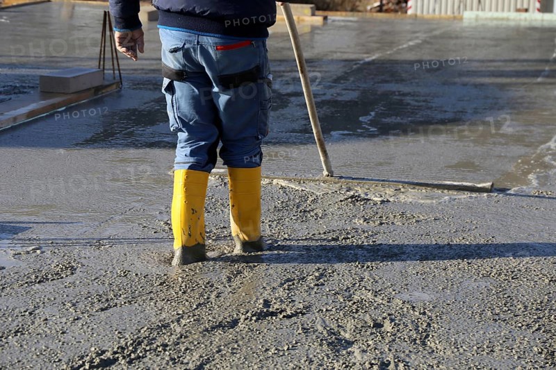 Concreting a floor slab with ready-mixed concrete on the construction site of a residential building