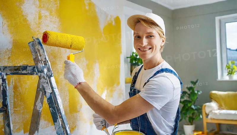 AI generated, man, men, a painter paints a wall with new yellow paint, father, renovation of old flat, paint roller, ladder, yellow, paint, 25, 30, years, a, person, occupation, occupations, leisure activity, family, smiles, smiling, fun at work, laughing, laughing, laughing, friend, partner, man